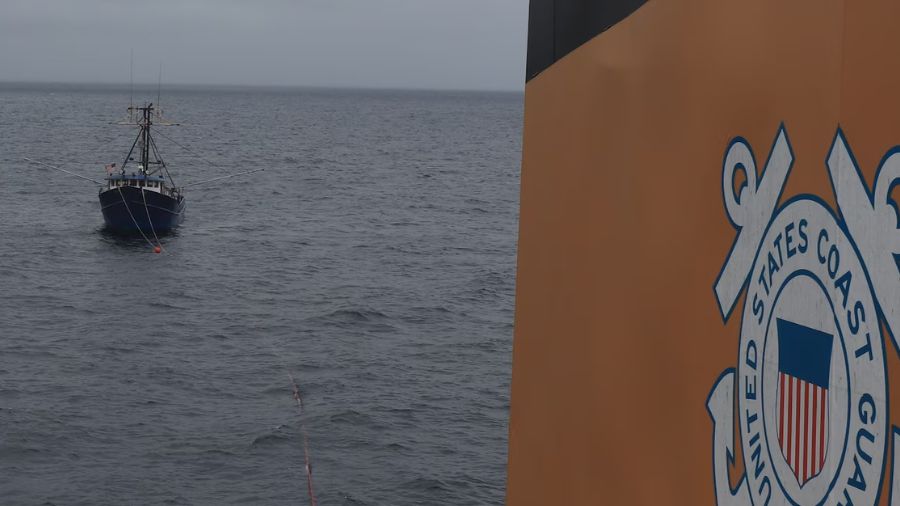 The U.S. Coast Guard tows a disabled, 97-foot fishing boat with three people aboard, after the vess...