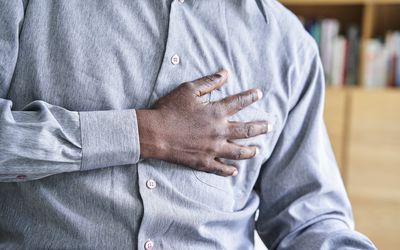 Close-up shot of Black man holding his hand to his chest