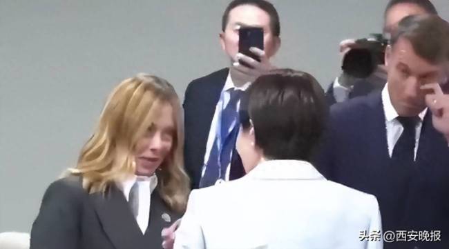 高市早苗搂肩熊抱滑椅子，别人聊天时站中间尬笑！