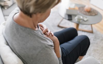 A person clutching their chest at home