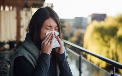 Woman with a tissue who looks like she may have congestion